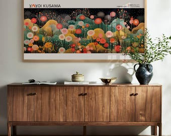 May include: A framed art print featuring a colorful floral landscape with the text "YAYOI KUSAMA" at the top. The artwork showcases a variety of flowers in shades of orange, pink, yellow, and green. The print is displayed above a wooden cabinet.
