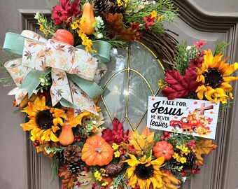 Farmhouse Fall for Jesus red truck sign on a grapevine wreath with pumpkins, sunflowers and pinecones fall foliage and greenery with bow