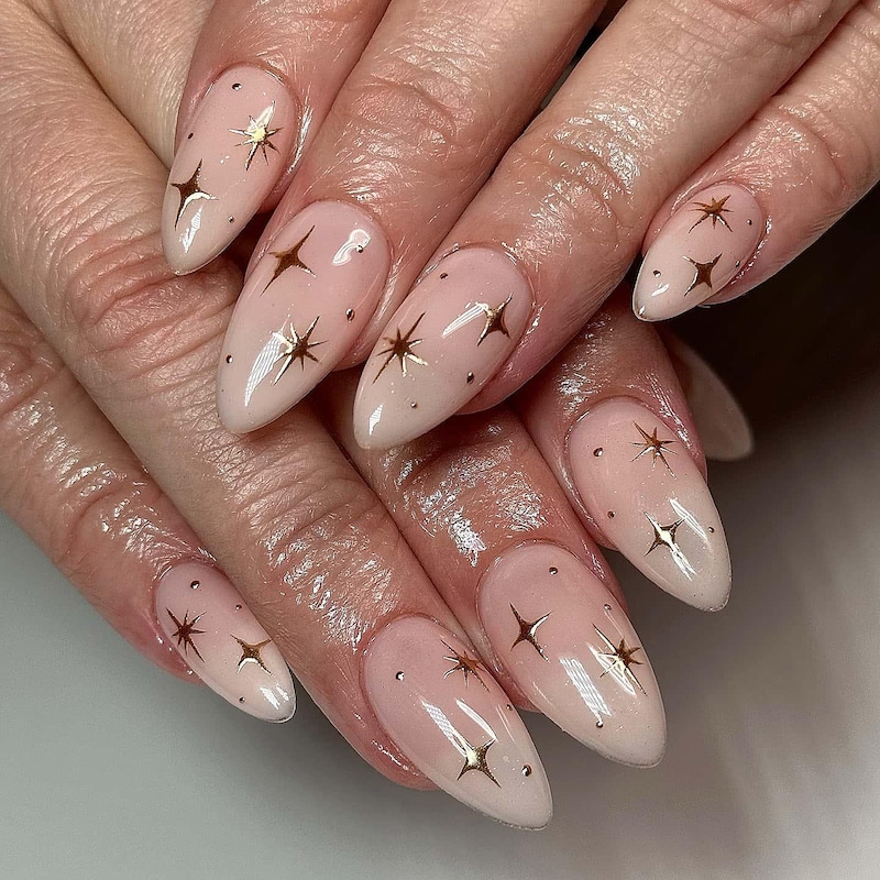 Nude nails with tiny gold star stickers