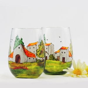 Set of 2 hand painted stemless wine glasses featuring a French or Tuscan village landscape. All painted freehand with gorgeous transparent paints.