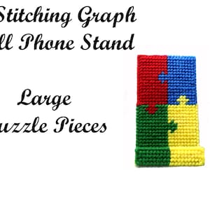 May include: Stitching graph pattern for a cell phone stand. The pattern is made up of large puzzle pieces in red, blue, green, and yellow.