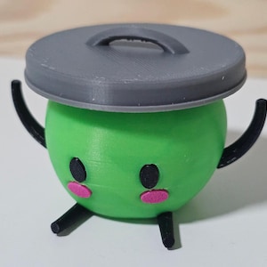 May include: A quirky 3D-printed character with a green body and a grey lid resembling a bin. It has black eyes, pink cheeks, and black arms and legs. The figurine is designed to stand upright, giving it a playful and unique appearance.
