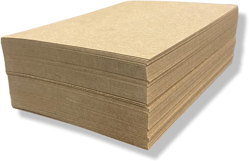 May include: A stack of brown craft paper sheets. The paper is smooth and has a slightly textured surface.