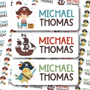 May include: Pirate-themed name labels featuring the name "Michael Thomas" in bold text. The labels showcase illustrations of a pirate boy, a pirate ship, and a pirate parrot. The labels are white with colorful accents and are ideal for kids.