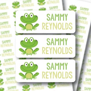 May include: White rectangular labels with a green frog graphic and the name "SAMMY REYNOLDS" in green text. Additional labels with the same design are visible in the background. The labels are suitable for kids.