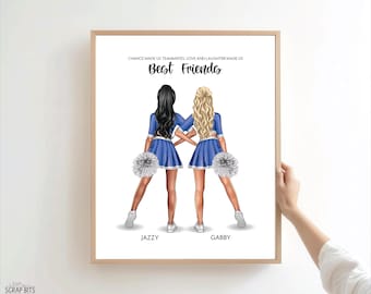 May include: A framed print featuring two cheerleaders with their arms linked, wearing blue and white uniforms and holding white pom-poms. The text reads: CHANCE MADE US TEAMMATES, LOVE AND LAUGHTER MADE US BEST FRIENDS, with the names JAZZY and GABBY.