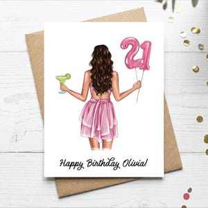 May include: A birthday card with an illustration of a person in a pink dress holding a cocktail and pink number 21 balloons. The card reads "Happy Birthday Olivia!" in black script.