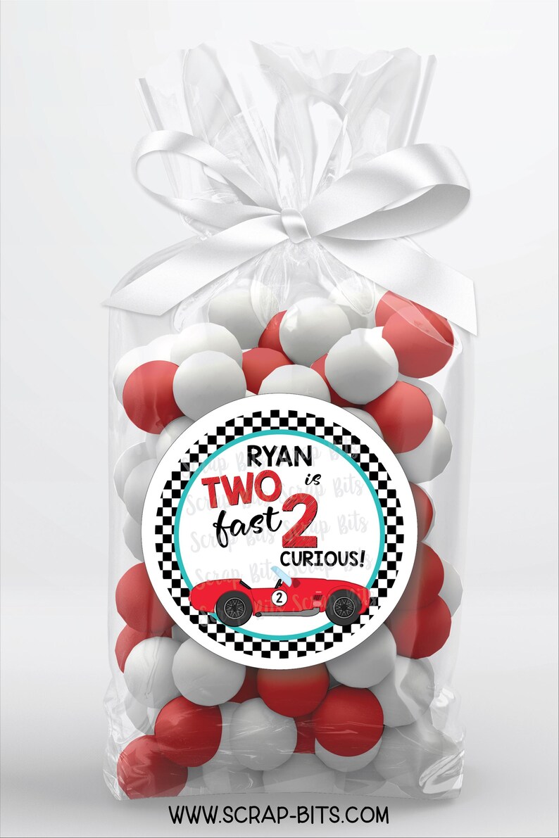 May include: A red and white checkered circle favor tag with a red race car and the text "Ryan is Two fast 2 curious!"  The tag is attached to a clear cellophane bag filled with red and white candy.