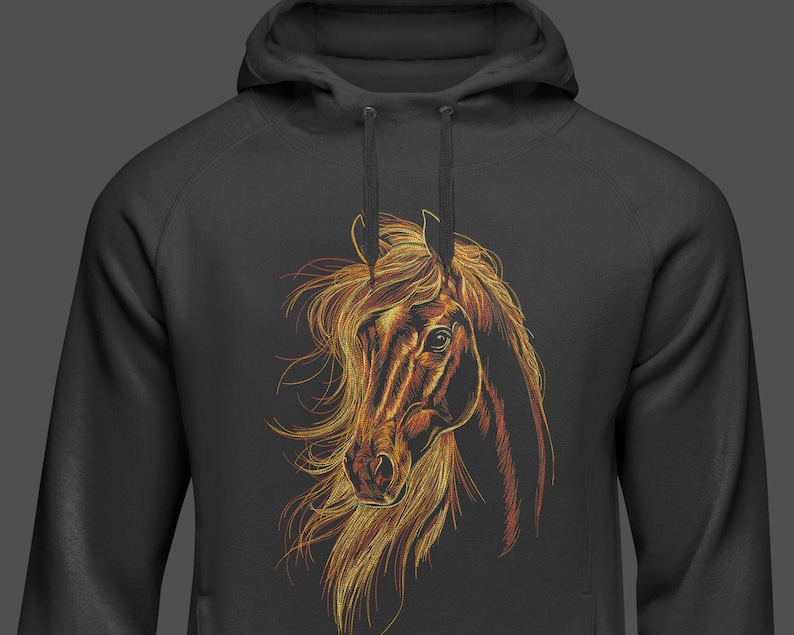May include: A black hoodie featuring a detailed illustration of a horse's head and flowing mane. The horse's head is rendered in shades of brown, gold, and orange, creating a striking contrast against the dark background of the hoodie.