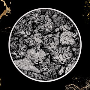 May include: A round, black and white illustration of several sleeping cats. The cats are clustered together, with their eyes closed and their bodies intertwined. The artwork is detailed, with each cat's fur and features carefully rendered.