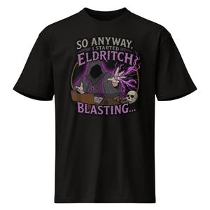 May include: Black t-shirt with a graphic of a robed figure casting purple energy, a skull, and the text "SO ANYWAY, I STARTED ELDRITCH BLASTING..." in purple and white. The design is centered on the front of the tee.