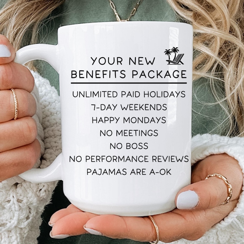A person holding a white mug with text on it, which appears to be a benefits package description.