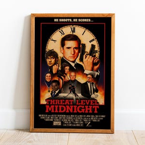 May include: A framed movie poster for "Threat Level Midnight" featuring a central image of a man holding two guns. The poster has a black background with red text and a clock face design. The text "HE SHOOTS, HE SCORES..." is at the top.