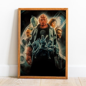 May include: A framed movie poster featuring a group of characters. The central figure is a red-skinned humanoid with horns, surrounded by other characters in a dark, action-oriented scene. The frame is made of wood.