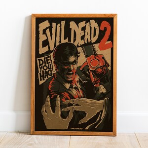 Puede incluir: Póster enmarcado de la película "Evil Dead 2" con un marco de madera marrón. El póster presenta un personaje amenazante sosteniendo una motosierra, con el título de la película y la frase "Die You Hag" en negrita. La obra de arte utiliza tonos de rojo, negro y marrón.