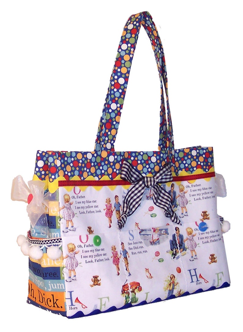 May include: A blue and white polka dot tote bag with a black and white checkered ribbon bow. The bag has multiple pockets with colorful illustrations of children and animals. The text on the pockets reads "Oh, Father, I see my blue car. I see my yellow car. Look, Father, look." and "See Jane run. See Dick run. Run, run, run."