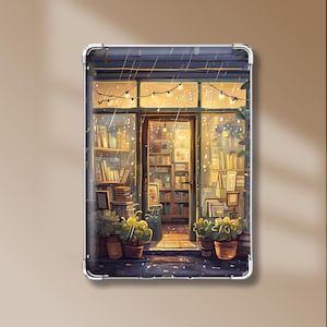 May include: A clear protective tablet case featuring a printed illustration of a bookstore storefront at night during a rainstorm. The design displays warm interior lighting, shelves filled with books, and potted plants near the entrance.