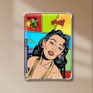 May include: A rectangular tablet case featuring a pop art comic book illustration. The design shows a distressed person with dark hair, a flying superhero in a green suit, and the word BANG in a yellow burst against a colorful panel background.