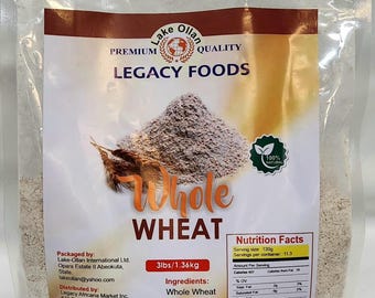 May include: A white bag of Lake Ollan Legacy Foods Whole Wheat flour. The bag is labeled with the product name, weight (3 lbs / 1.36 kg), ingredients, storage instructions, and nutrition facts. The bag is 100% natural and a product of Nigeria.