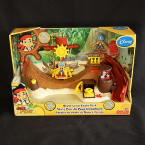 May include: A boxed Jake and the Never Land Pirates Skate Park playset. The toy set features a pirate ship design with a ramp, figures, and accessories. The box has the Disney logo and the text "Never Land Skate Park".