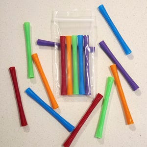 May include: A set of three ceramic mugs with a speckled, matte finish. The mugs are in shades of cream, light gray, and dark gray. Each mug has a simple, minimalist design, perfect for coffee or tea.