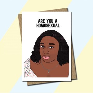 May include: Greeting card with the text "ARE YOU A HOMOSEXUAL" above an illustration of a woman with dark hair and a cross necklace. The card is on a brown envelope.