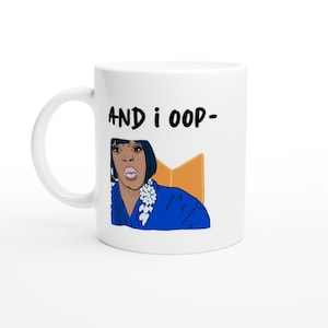 May include: White ceramic mug with a black and white illustration of a woman with a surprised expression. The text "AND i OOP- " is printed in black on the mug.