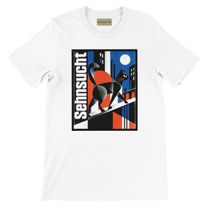 May include: A white short-sleeve t-shirt featuring a rectangular graphic print of a black cat walking on a ledge against a city skyline. The design includes a large red circle, a white moon, and the word "Sehnsucht" printed vertically in white.