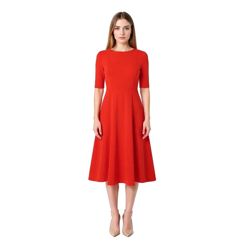 May include: A solid red midi dress featuring a round neckline, short sleeves, and a fitted bodice that transitions into a flared, A-line skirt. The dress has a clean, structured silhouette with visible seam detailing along the waist and bodice.