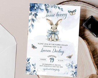 May include: A baby shower invitation featuring a watercolour illustration of a blue bunny with a blue bow. The invitation reads "some bunny" at the top and "Lauren Darling" in a blue script font. The date of the shower is 19th February at 6 PM.