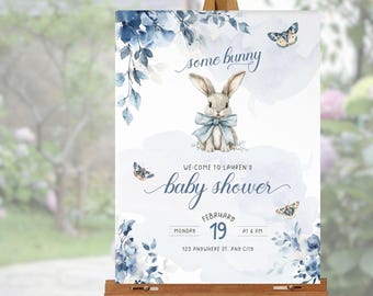 May include: Blue and white baby shower sign with a watercolor bunny and butterflies. The sign says "some bunny" and "We come to Lauren's baby shower" with the date and time of the event.