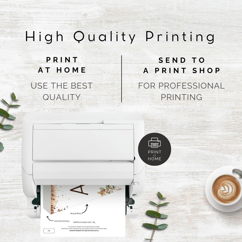 May include: A white printer with a printable design for a wedding invitation. The design features a floral pattern with a gold glitter background and the letter "A". The text "Print at Home" is visible on the printer.