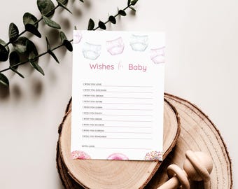 May include: A white card with pink and blue watercolor illustrations of diapers and donuts. The card has the text "Wishes for Baby" and a list of wishes for a baby, such as "I wish you love", "I wish you discover", "I wish you dream", "I wish you share", "I wish you learn", "I wish you enjoy", "I wish you grow", "I wish you achieve", "I wish you cherish", "I wish you remember", and "With love".