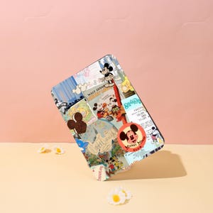 May include: A rectangular case featuring a collage of Mickey Mouse imagery. The design includes vintage posters, character illustrations, and the Mickey Mouse Club logo. The case has a black border and is set against a pink and beige backdrop.