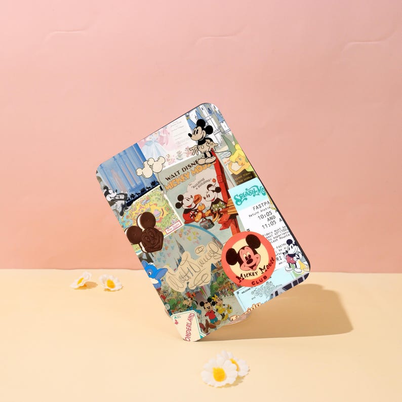 May include: A rectangular case featuring a collage of Mickey Mouse imagery. The design includes vintage posters, character illustrations, and the Mickey Mouse Club logo. The case has a black border and is set against a pink and beige backdrop.
