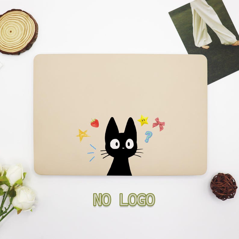 May include: A beige laptop skin with a black cat illustration and colorful stars, a question mark, and strawberries. The text "NO LOGO" is printed below the image.