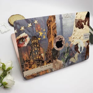 May include: A laptop skin with a collage of images, including a building, stars, an eye, a moon, and a butterfly. The text "in the end... we'll all become stories." is printed on the bottom of the skin.