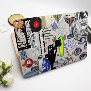 May include: A laptop computer with a colorful collage of stickers featuring images of eyes, a zebra, a beetle, a record, a hand, a car, and text that says "Get out of bed! Do the things, own your life!" and "Take more chances, dance more dances."