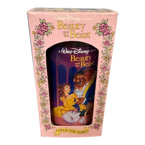 May include: A pink box with a picture of Belle and the Beast from Disney's Beauty and the Beast. The box says "A Walt Disney Classic Beauty and the Beast Collector Series".
