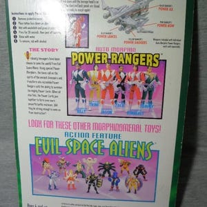 May include: Back of a Power Rangers toy package featuring the Power Rangers team, including Billy, Trini, Jason, Zack, Kimberly, and Tommy. The package also shows Evil Space Aliens action figures and instructions.