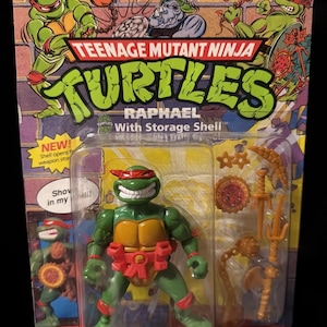 May include: A Teenage Mutant Ninja Turtles Raphael action figure in its original packaging. The green figure has a red mask and belt, with a yellow chest and accessories. The packaging features the Turtles logo and character art.