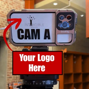 May include: A silver and black camera rig with the text "CAM A" and the "Intangible Productions" logo. The rig has a "SmallRig" label and a red rectangle with the text "Your Logo Here".