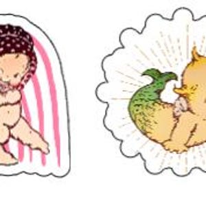 May include: Two vintage-style baby dolls, one with a pink and white striped background and the other with a yellow background and a sunburst design. The doll with the striped background is holding the other doll. Both dolls have blonde hair and blue eyes.