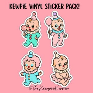 May include: A pack of vinyl stickers featuring four cartoon Kewpie doll characters dressed as clowns. Each doll has a different outfit and accessory, including a lollipop and a balloon. The stickers are on a pink background with the text "KEWPIE VINYL STICKER PACK!"