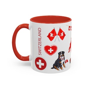 Pode incluir: Caneca de cerâmica branca com interior e alça vermelhos. A caneca apresenta ilustrações de bandeiras suíças, um coração com uma cruz, um boiadeiro bernês e a palavra "SUÍÇA".
