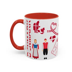 May include: White ceramic mug with a red interior and handle. The mug features a design with the word "DENMARK" in red, along with illustrations of the Danish flag, a map of Denmark, and traditional Danish figures.