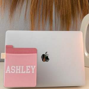 May include: A white ceramic mug with a black handle and the text "But First, Coffee" in a bold, black font. The mug is set against a blurred background, suggesting a cozy setting.