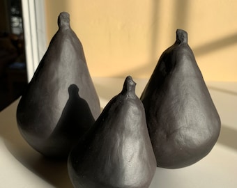 three black porcelain pears