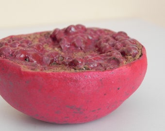 ruby red stoneware pomegranate half, faux food, photo stylist