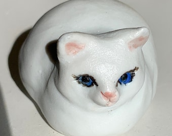 white porcelain kitten with blue eyes